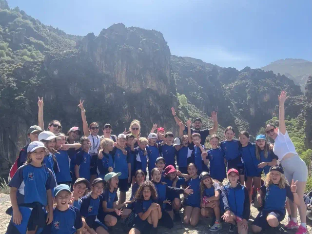 Year 5 pupils cheering at the foot of the cliffs at Los Cahorros