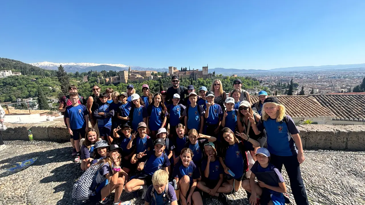 Year 5 group at a viewpoint with the Alhambra and Granada behind them
