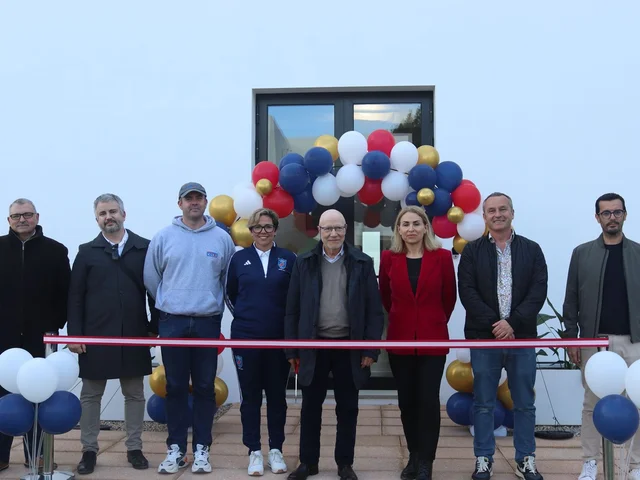Guests at the ribbon cutting for Morna's new sports hall in 2024