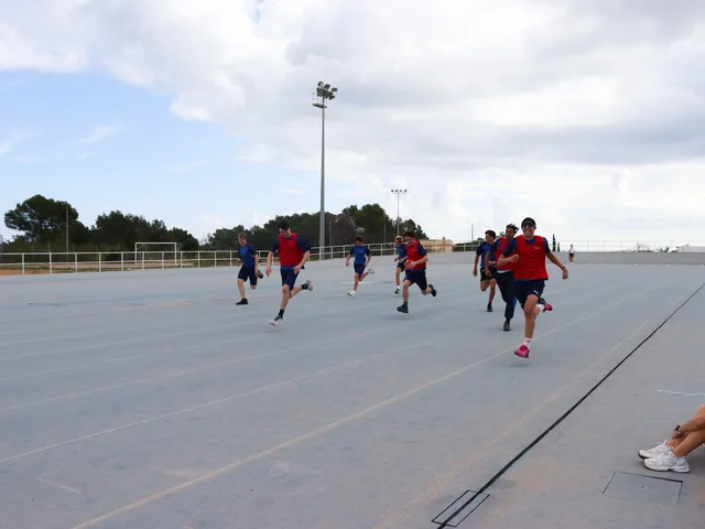 Students sprinting on the athletics track at Sports Day