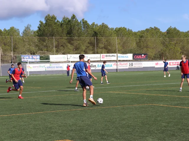 Secondary students playing football on a full-size pitch