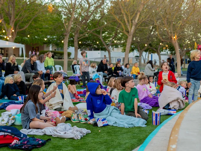 Families sitting on blankets on the lawn at the Stargazing Event