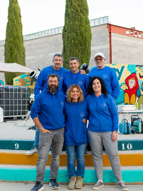 Astronomy volunteers in blue sweatshirts