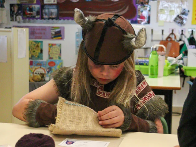 A pupil in a Viking costume taking part in a classroom activity on WOW Day