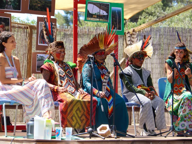Guest speakers in traditional dress at a Primary WOW Day presentation