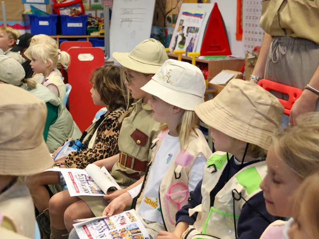 Primary pupils in explorers' costumes learning together on WOW Day
