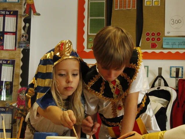 Primary pupils in Ancient Egyptian and Roman costumes during a classroom activity