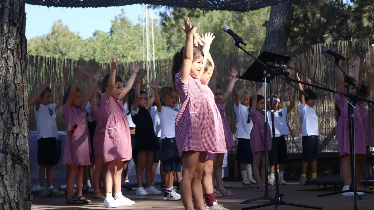 Primary children performing on the outdoor school stage
