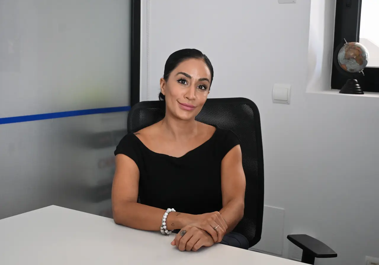 Zahrah Fazil, Head of Sixth Form, sitting at her desk