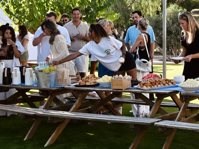 Morna parents gathered on the lawn around picnic tables laid with coffee, croissants and fruit at a PTA breakfast